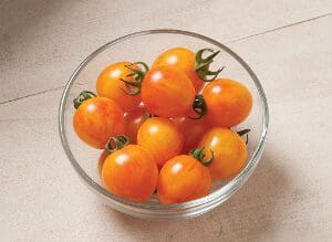 A bowl of fresh orange cherry tomatoes.