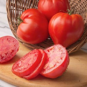 Fresh, ripe tomatoes with vibrant red color on a wooden board.