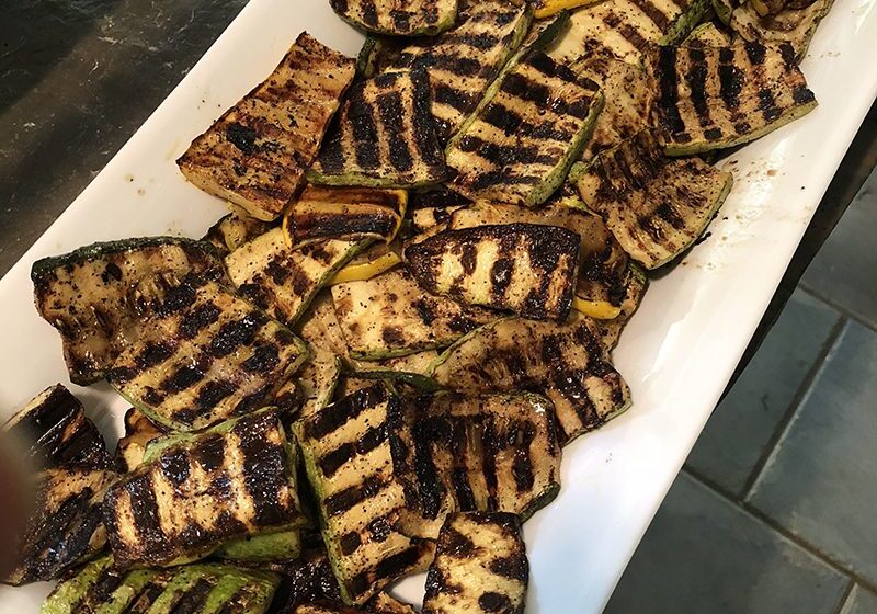 Grilled summer squash slices with charred marks